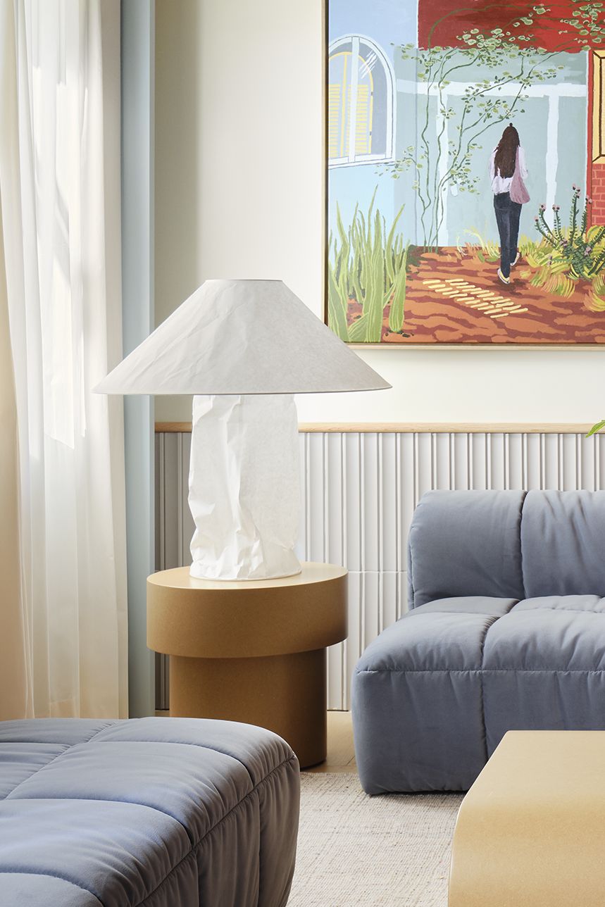 a modern living room design featuring a blue sofa, red vaulted ceiling and neutral walls