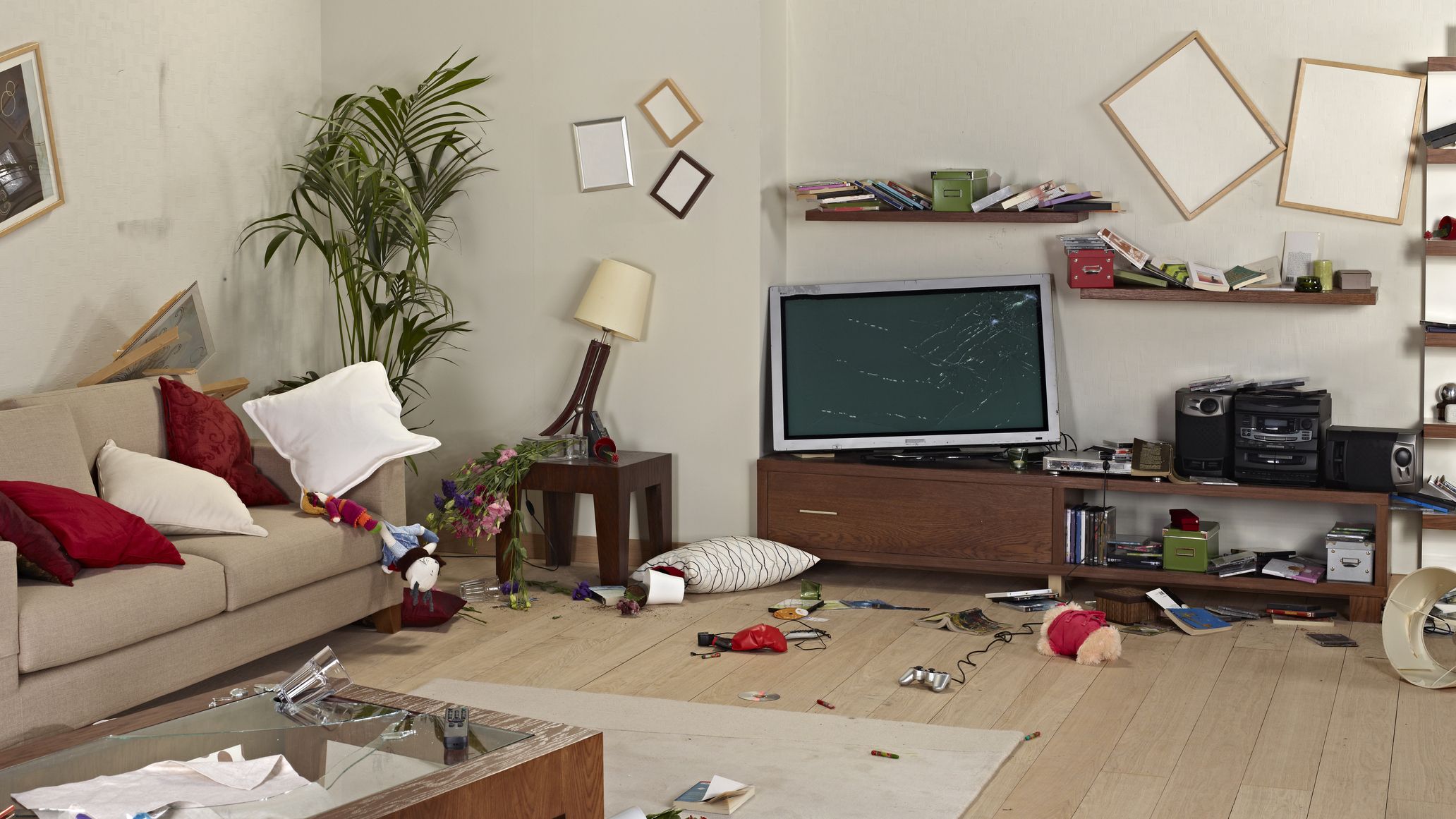 Furniture and belongings in a living room damaged by an earthquake.