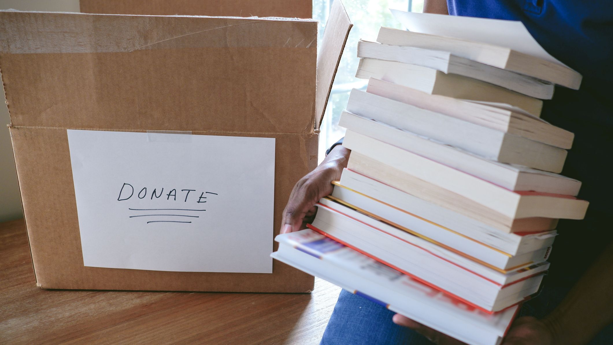 Woman Packs Books for Donation