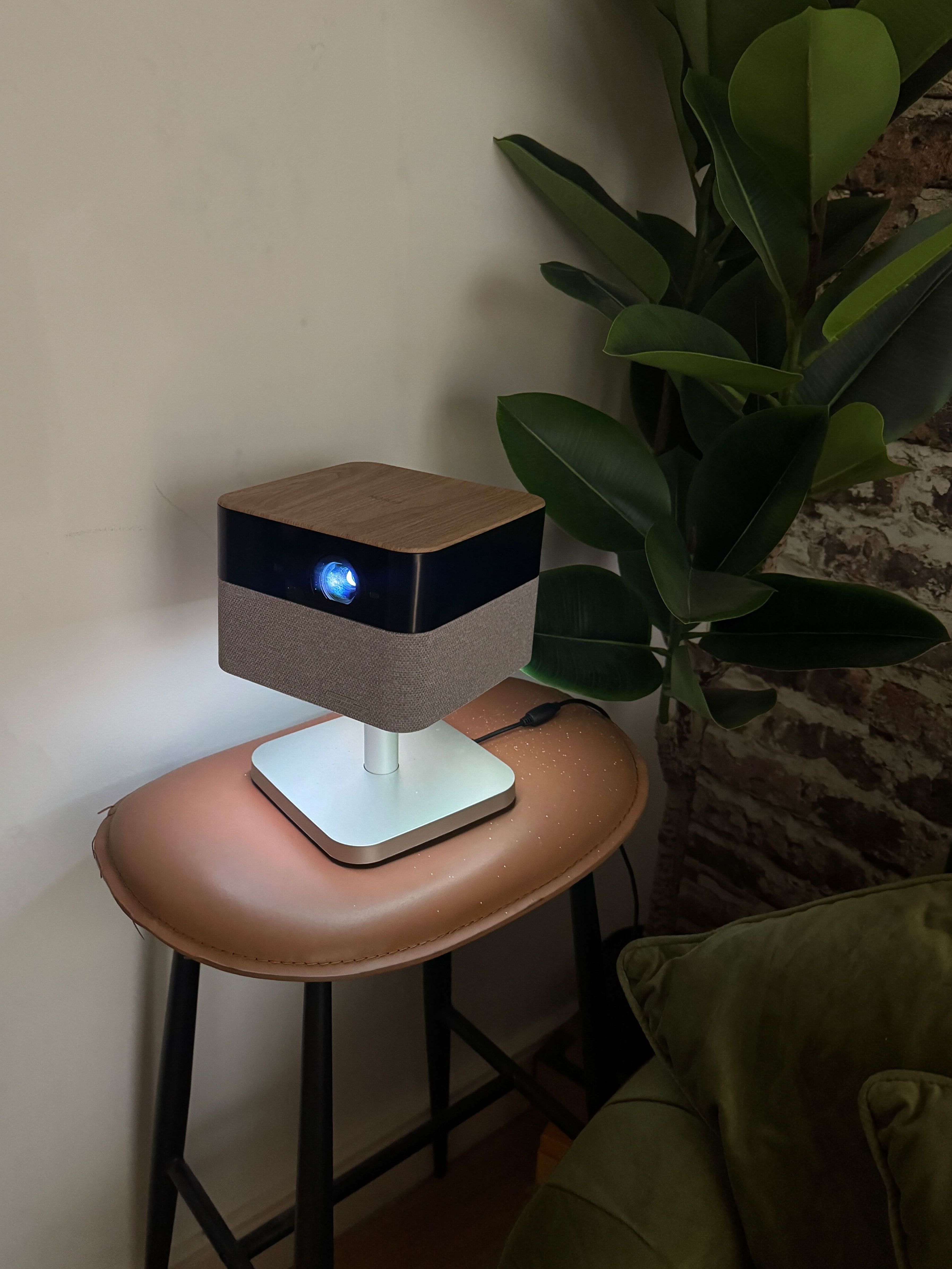 Epson Lifestudio Flex EF-72 projector on bar stool in from of plant