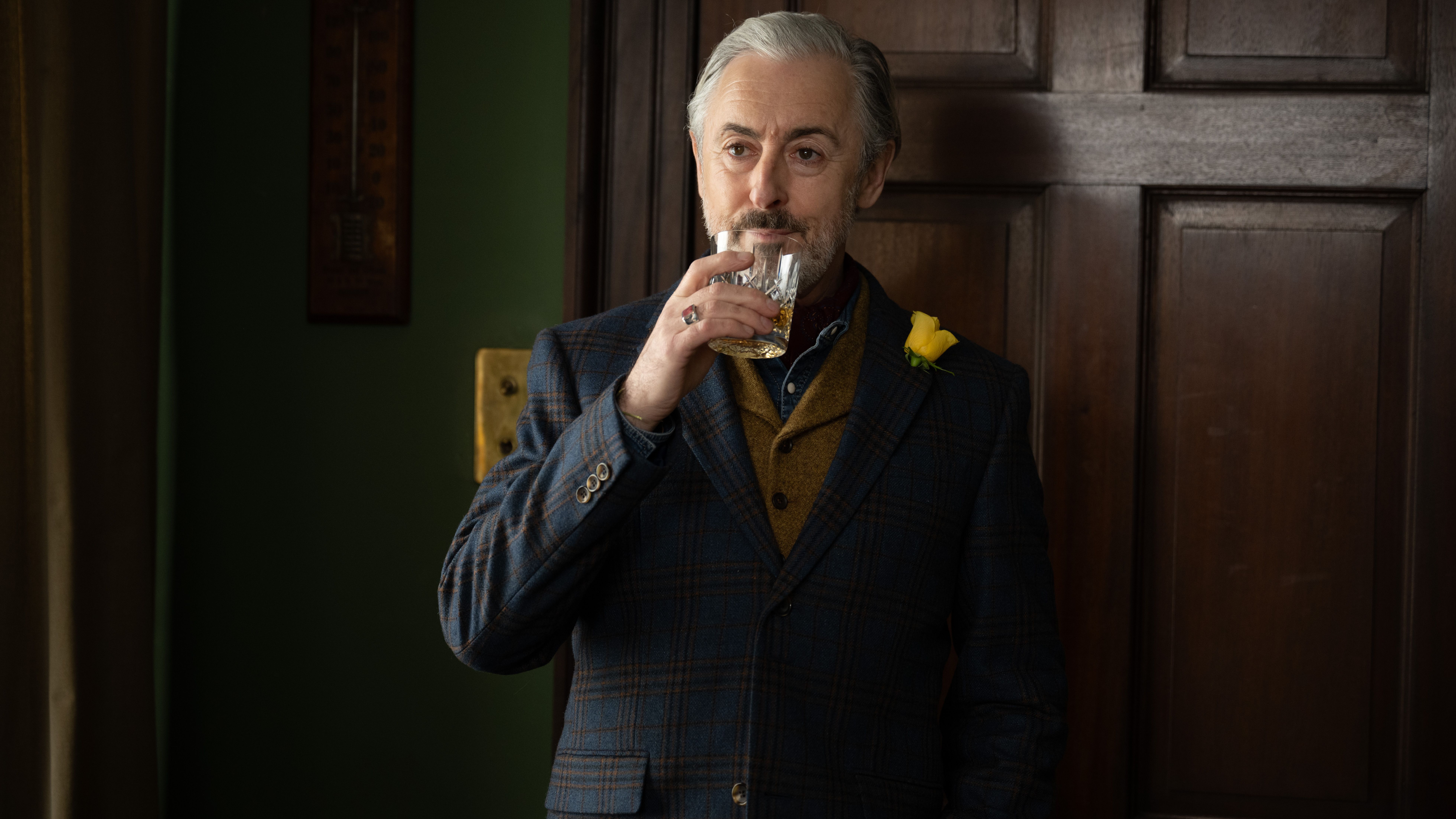 an image of alan cumming as donal in Glenrothan, drinking a glass of whisky