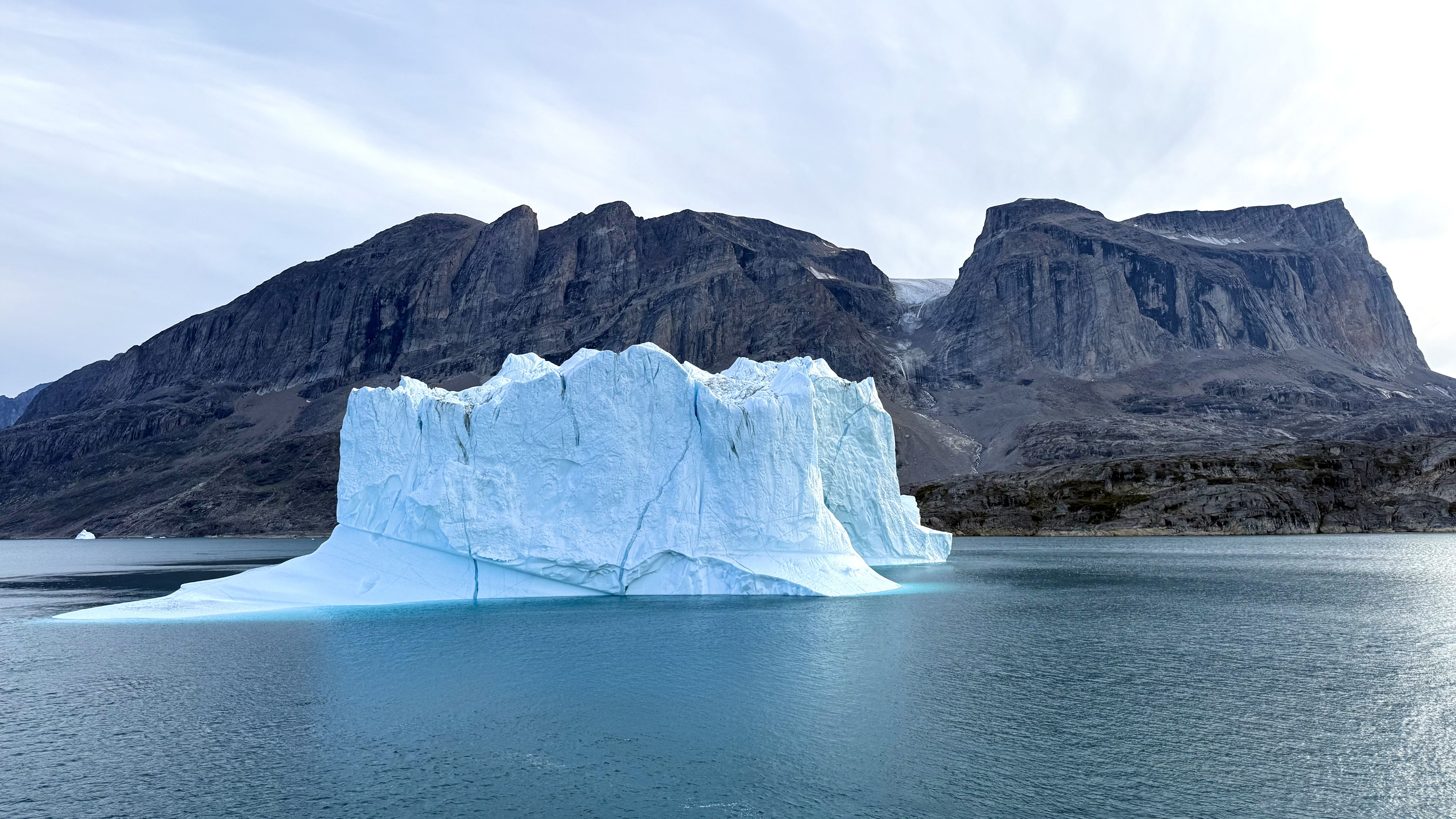 I sailed to Greenland for a total solar eclipse — what I saw left me speechless 2 MyCelestialApp a large iceberg appears to mimic the colossal mountains behind.