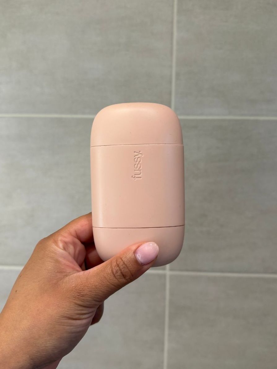 Aleesha holding empty Fussy deodorant