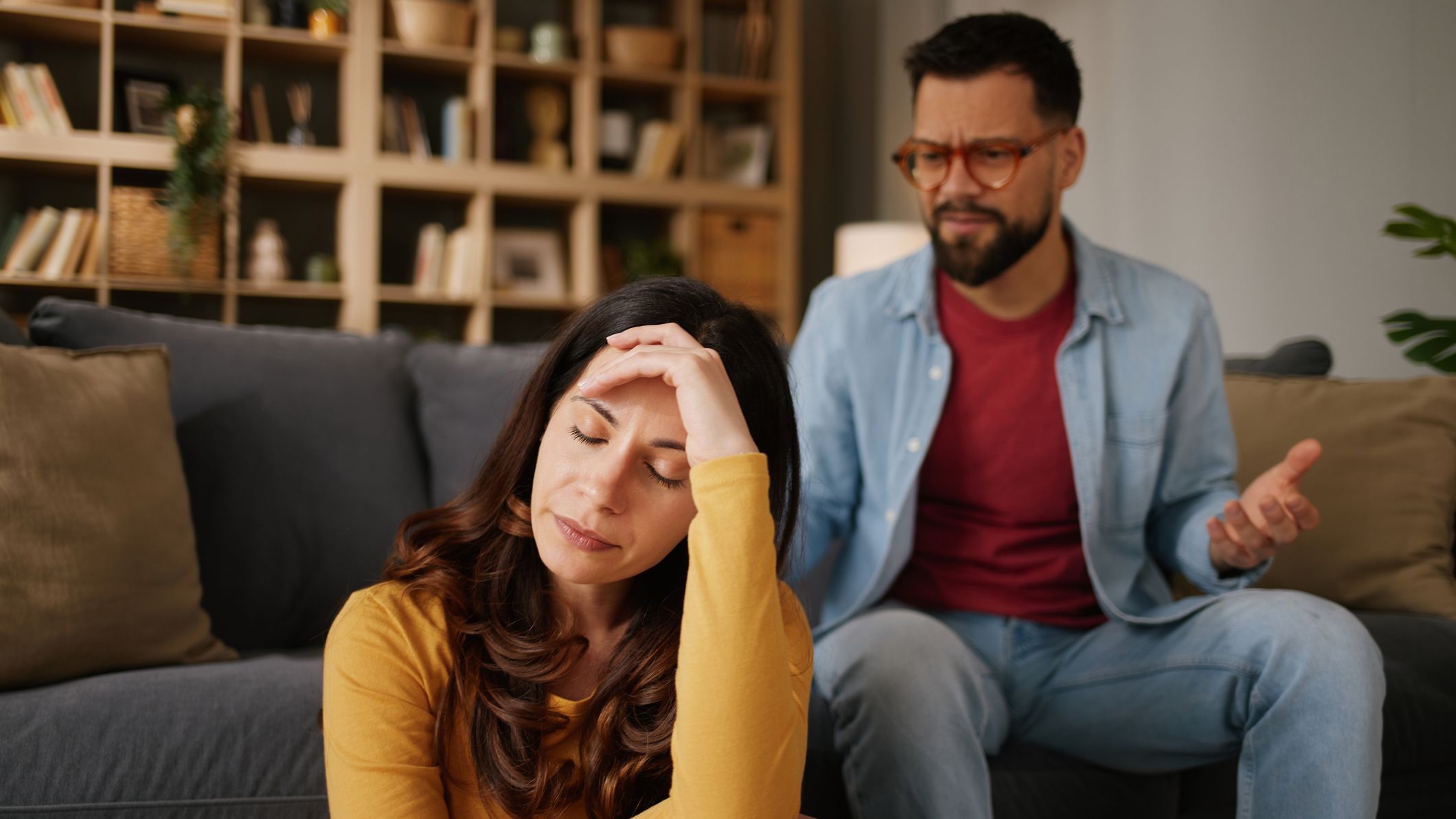 Couple having conflict, woman feeling stressed and upset