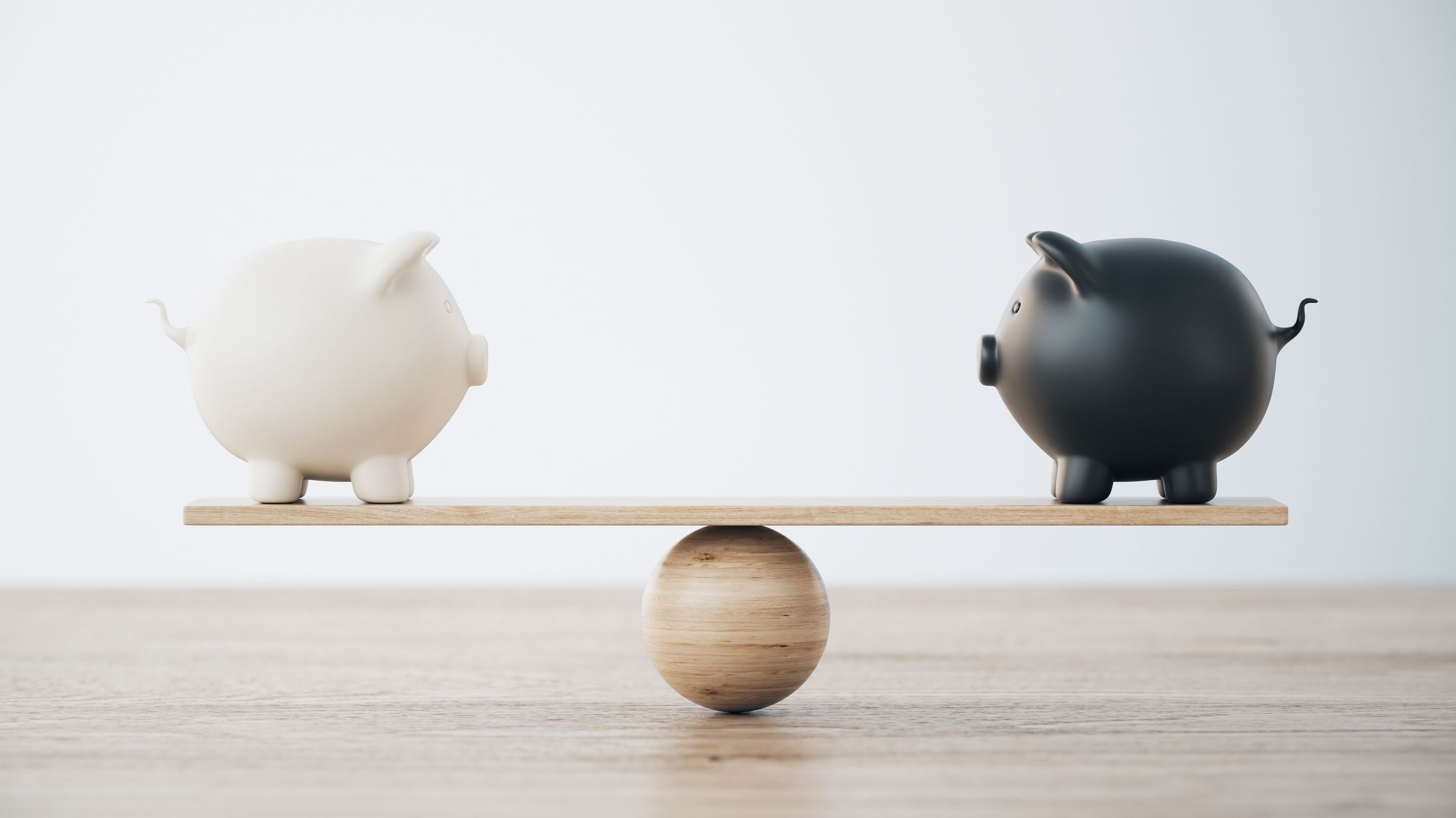 two piggy banks on opposite sides of a seesaw