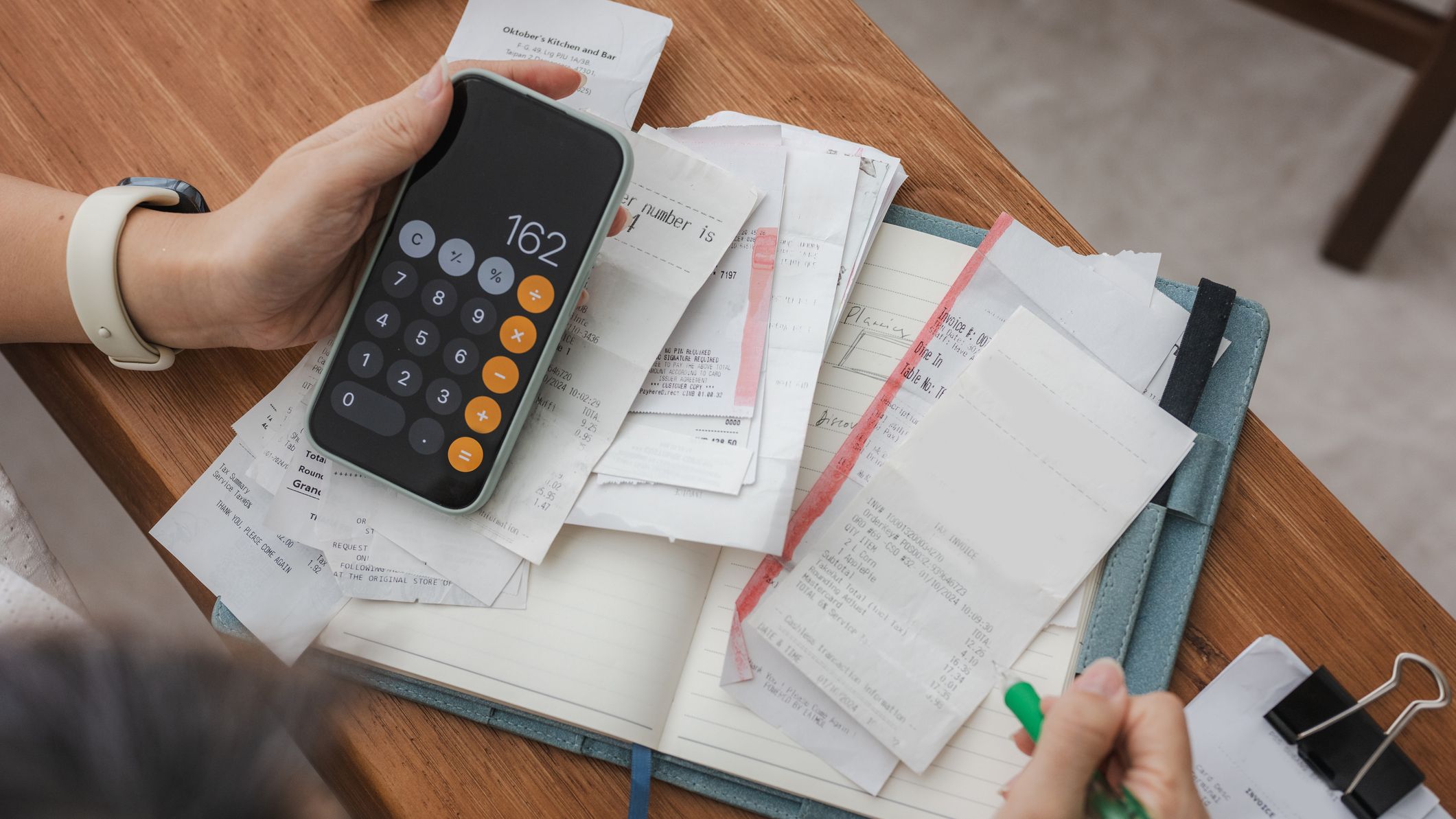 Close up a woman managing her home finances with a smartphone