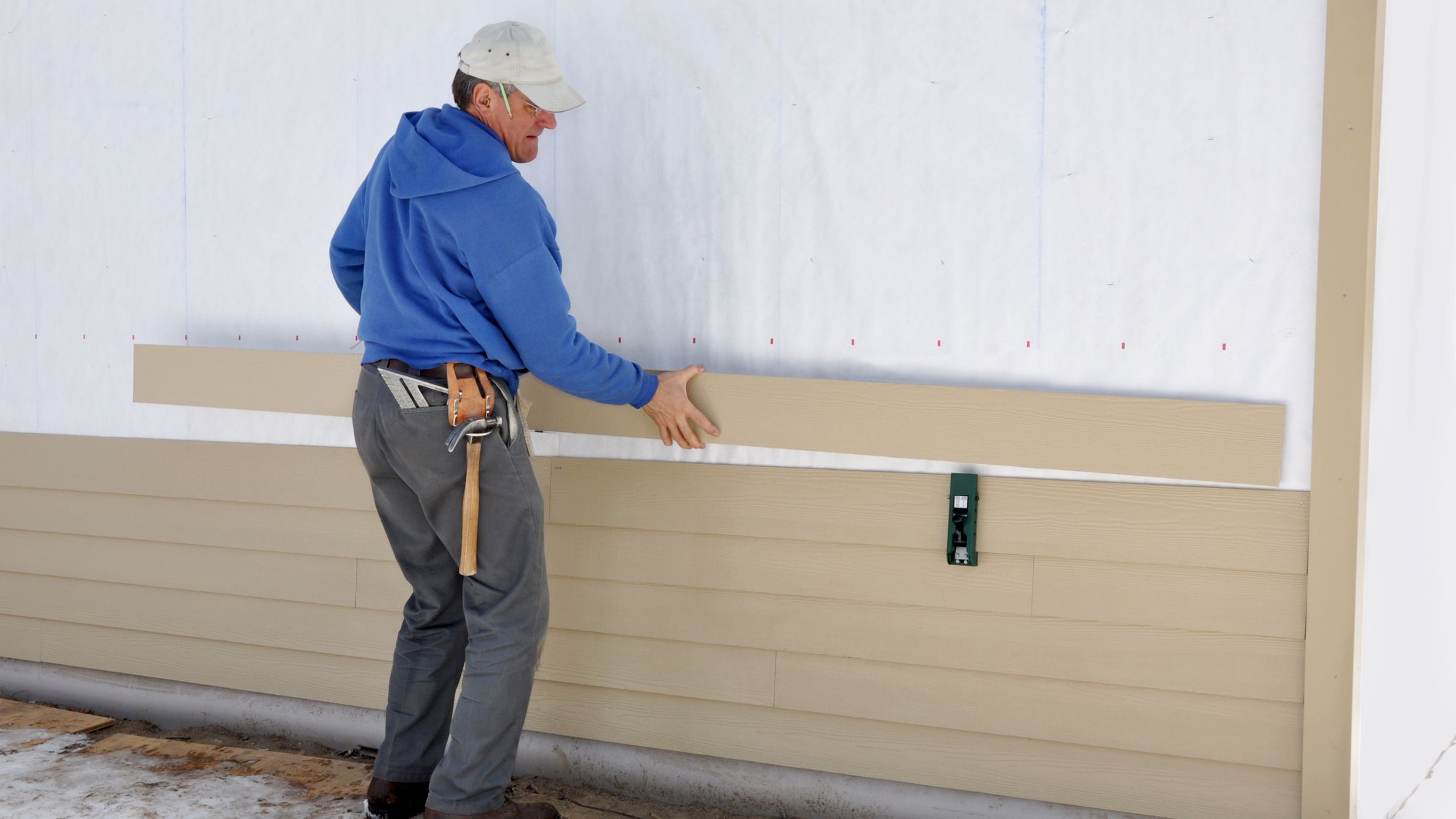 Carpenter installing siding