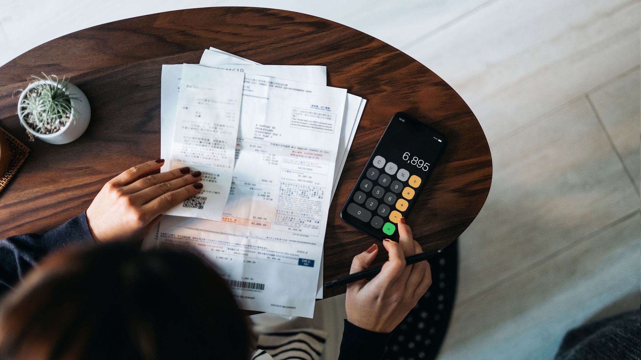 a person budgeting their bills at a desk
