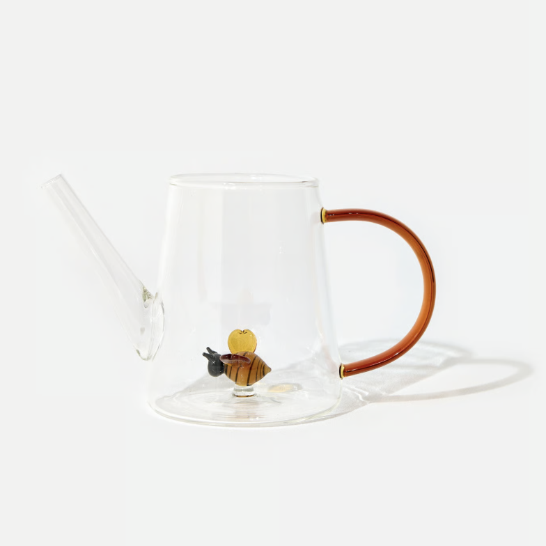 glass watering can with glass bee inside