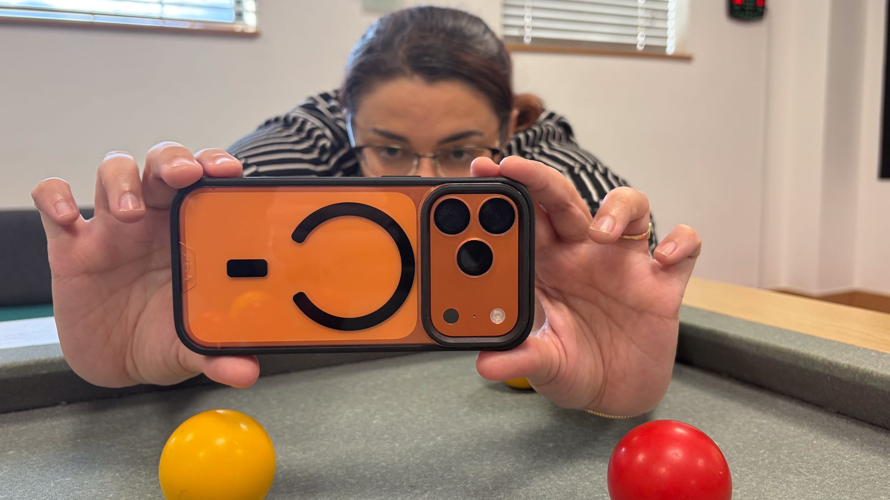 Person using an iPhone in a Mous Clarity iPhone 18 Pro case
