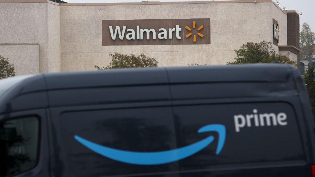 An Amazon Prime van parked in front of a Walmart store