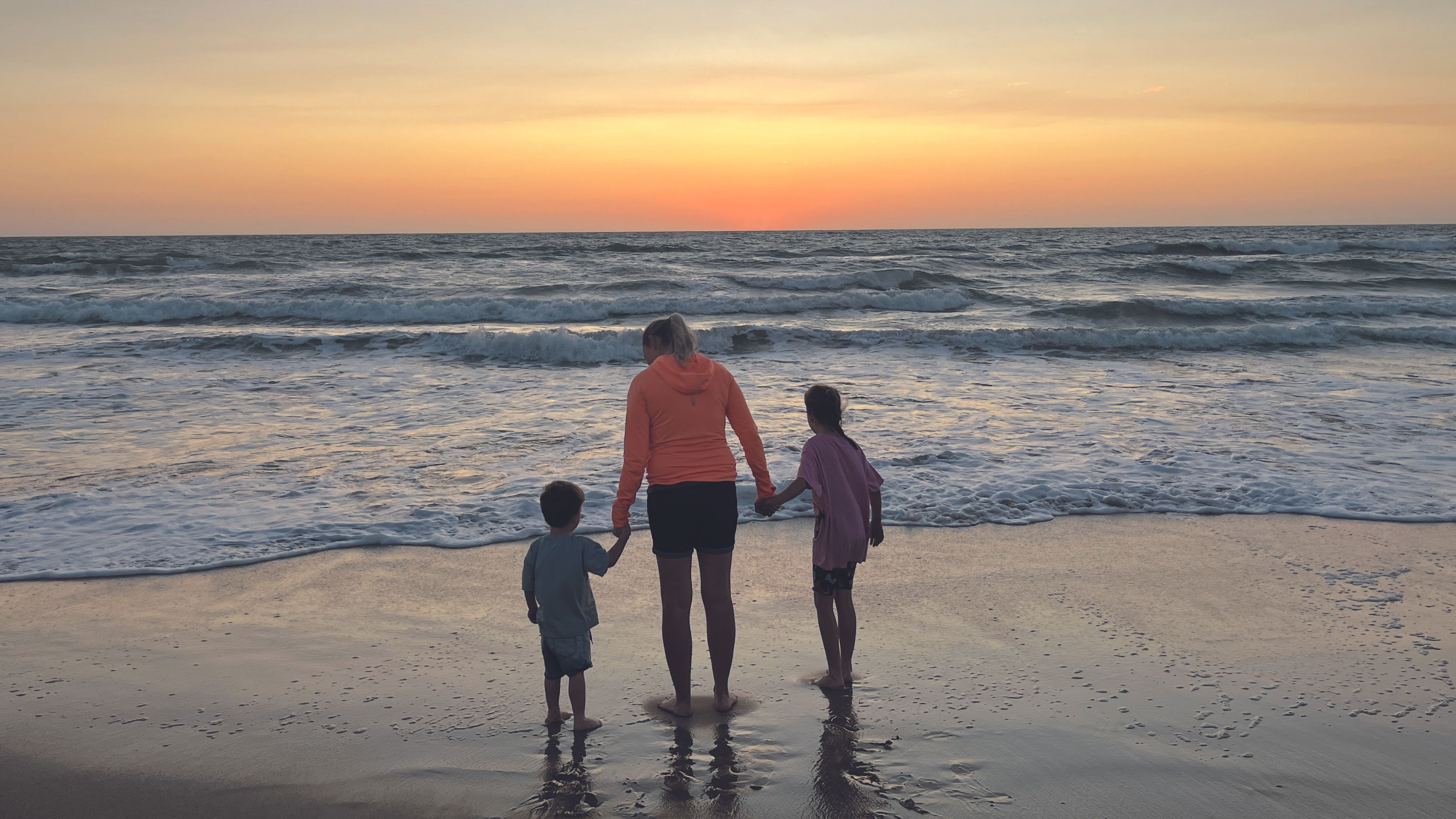 Amy Frain on the beach in Australia with her children