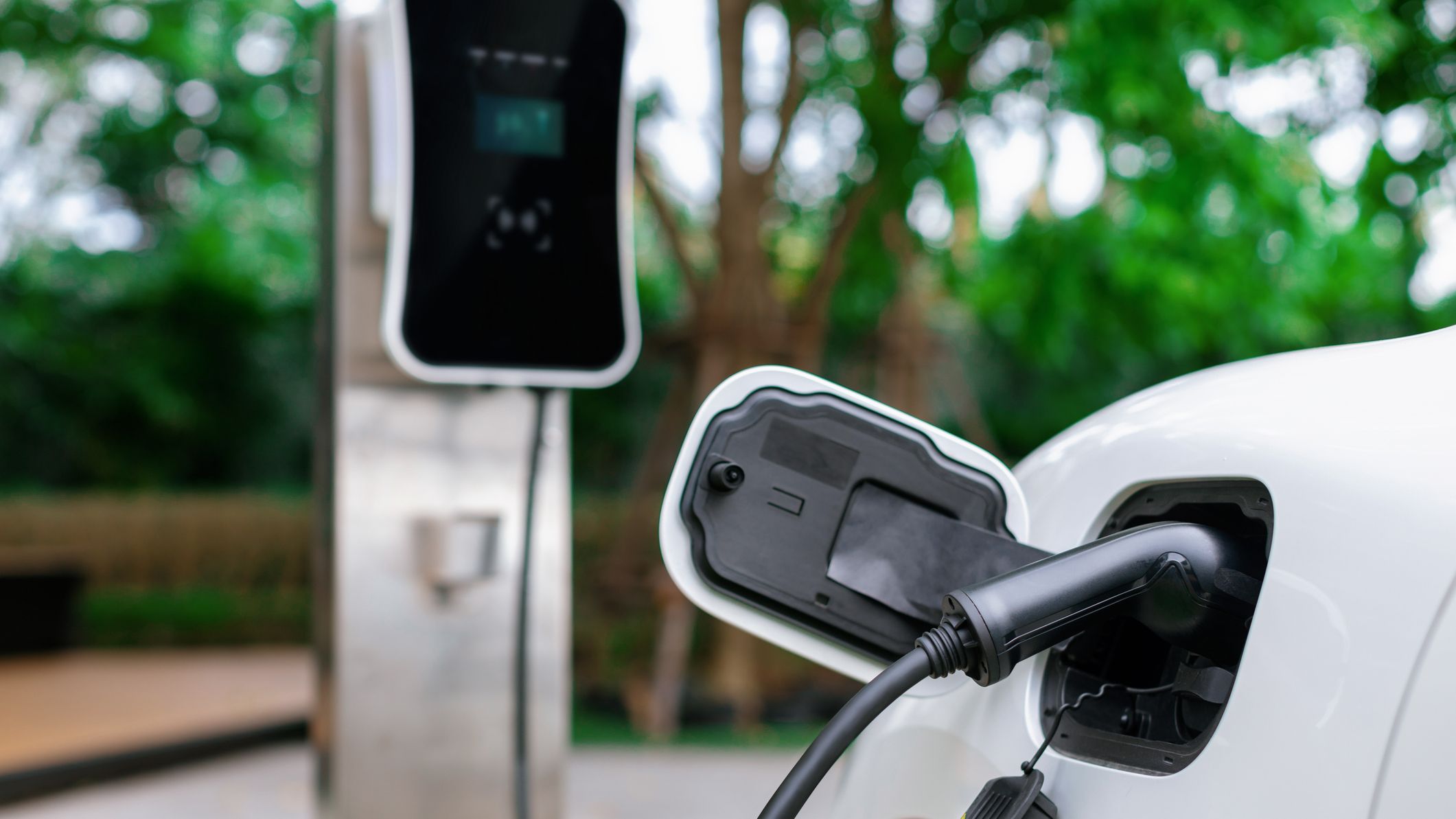 Focus closeup EV car and charger with blur background for progressive concept