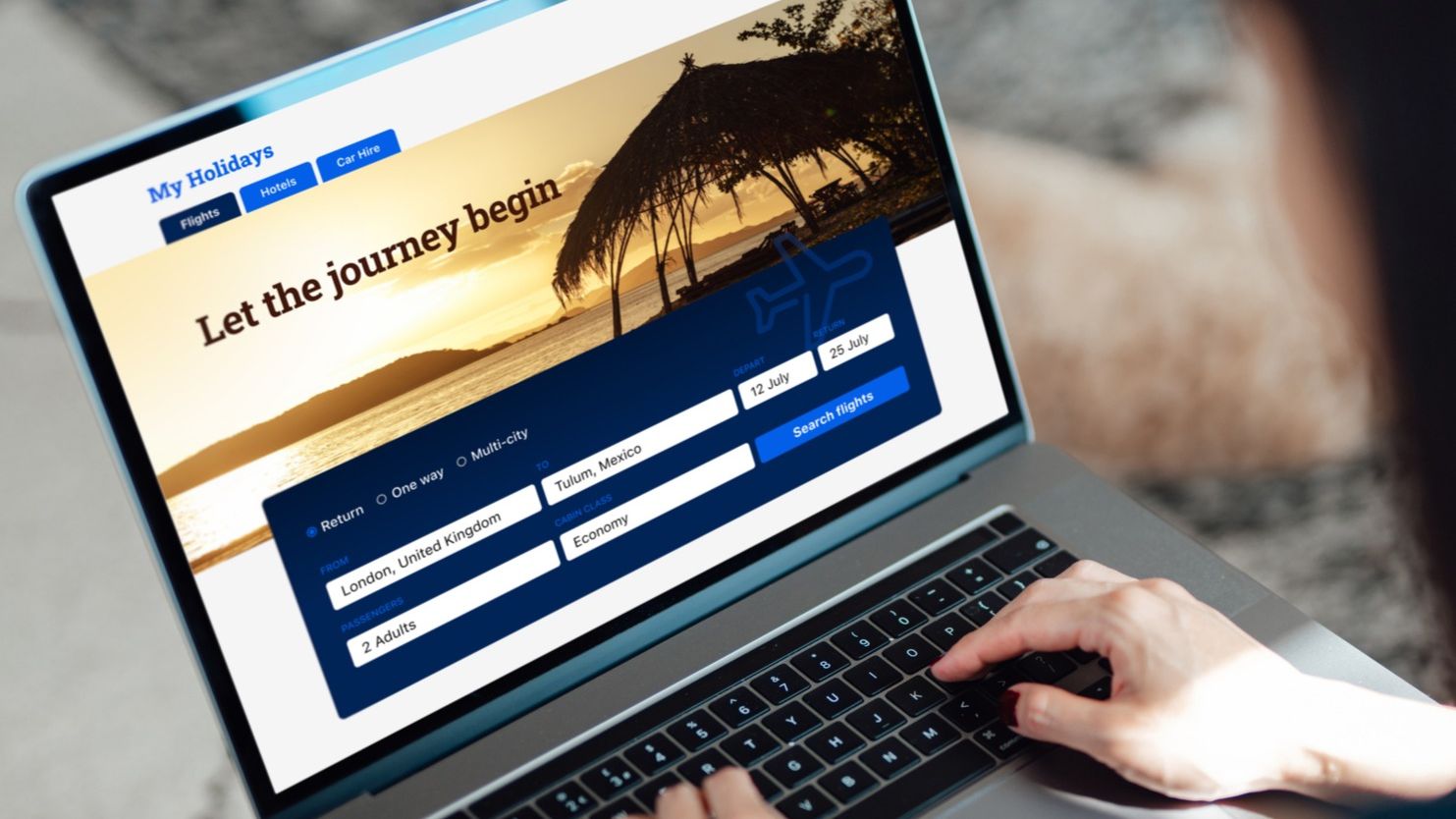 Woman using laptop to book flight tickets and plan holiday