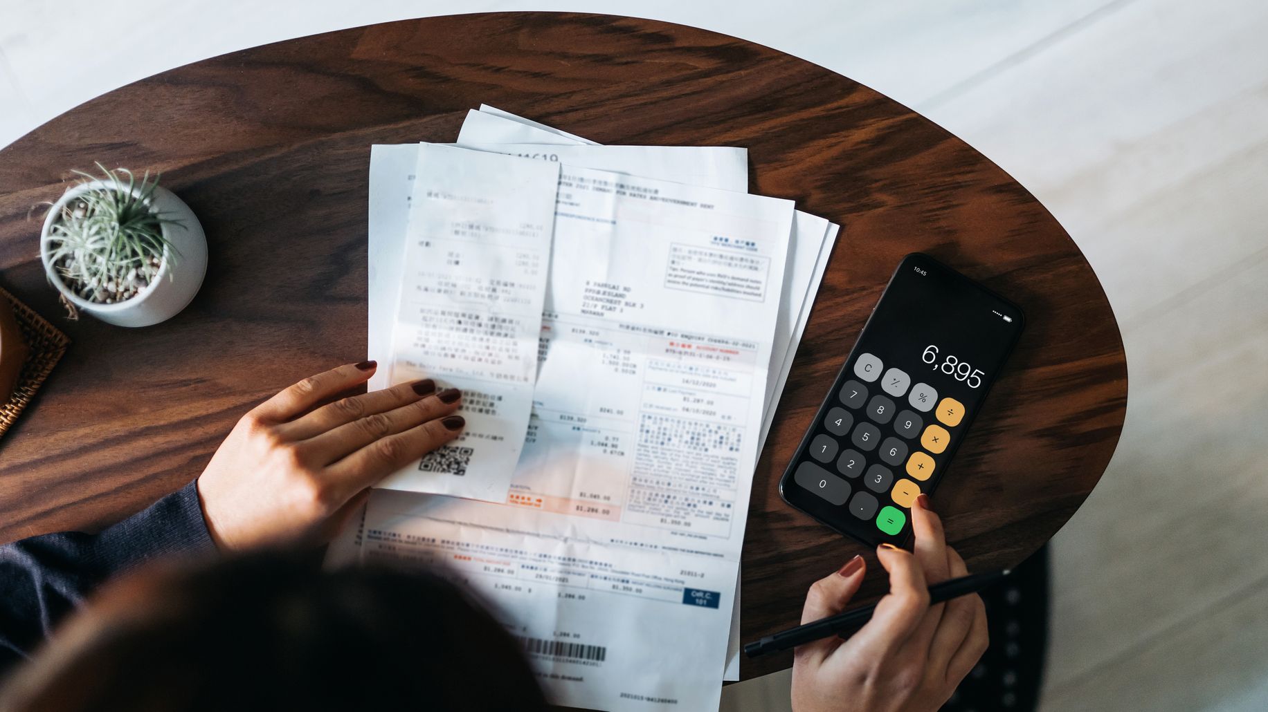 a person budgeting for bill payments