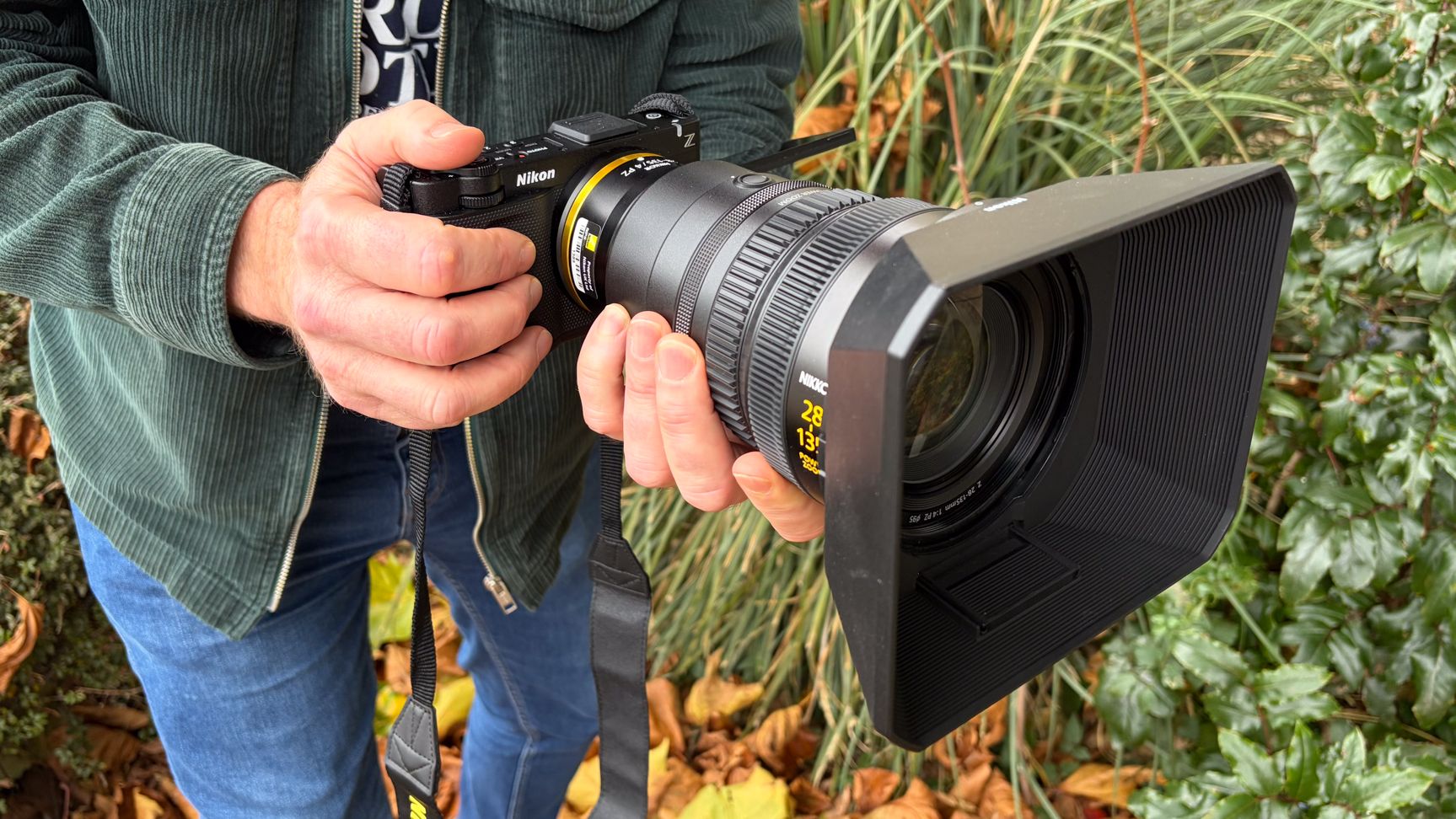 Person holding a Nikon ZR with Z 28-135mm f/4 PZ lens