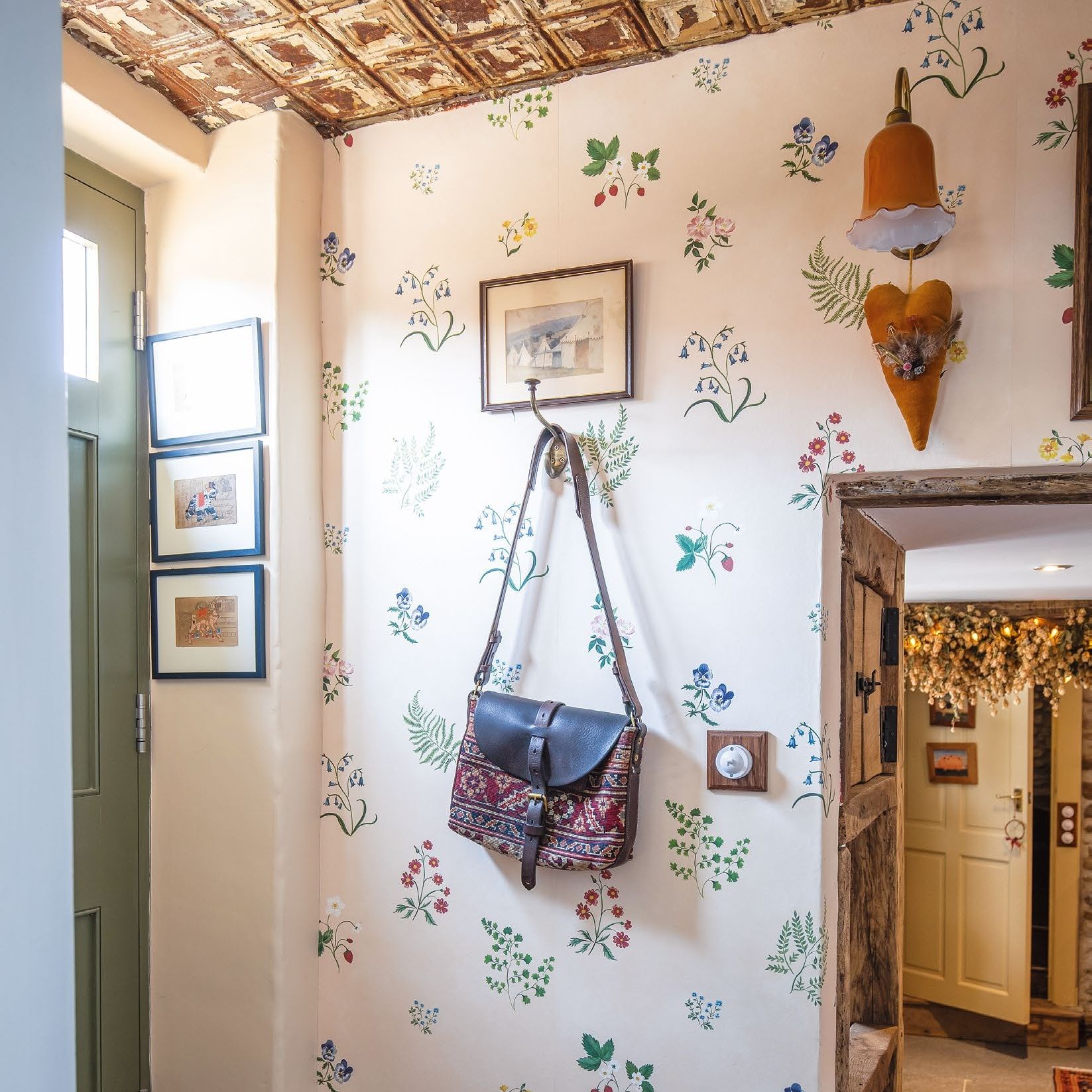 Country style hallway with floral wallpaper and tin tiled ceiling