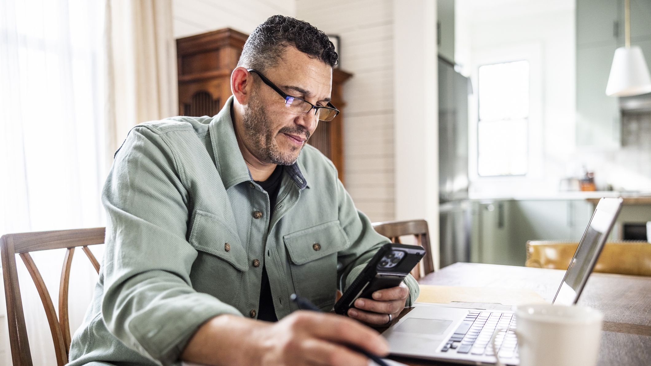 Middle aged man working from home with laptop