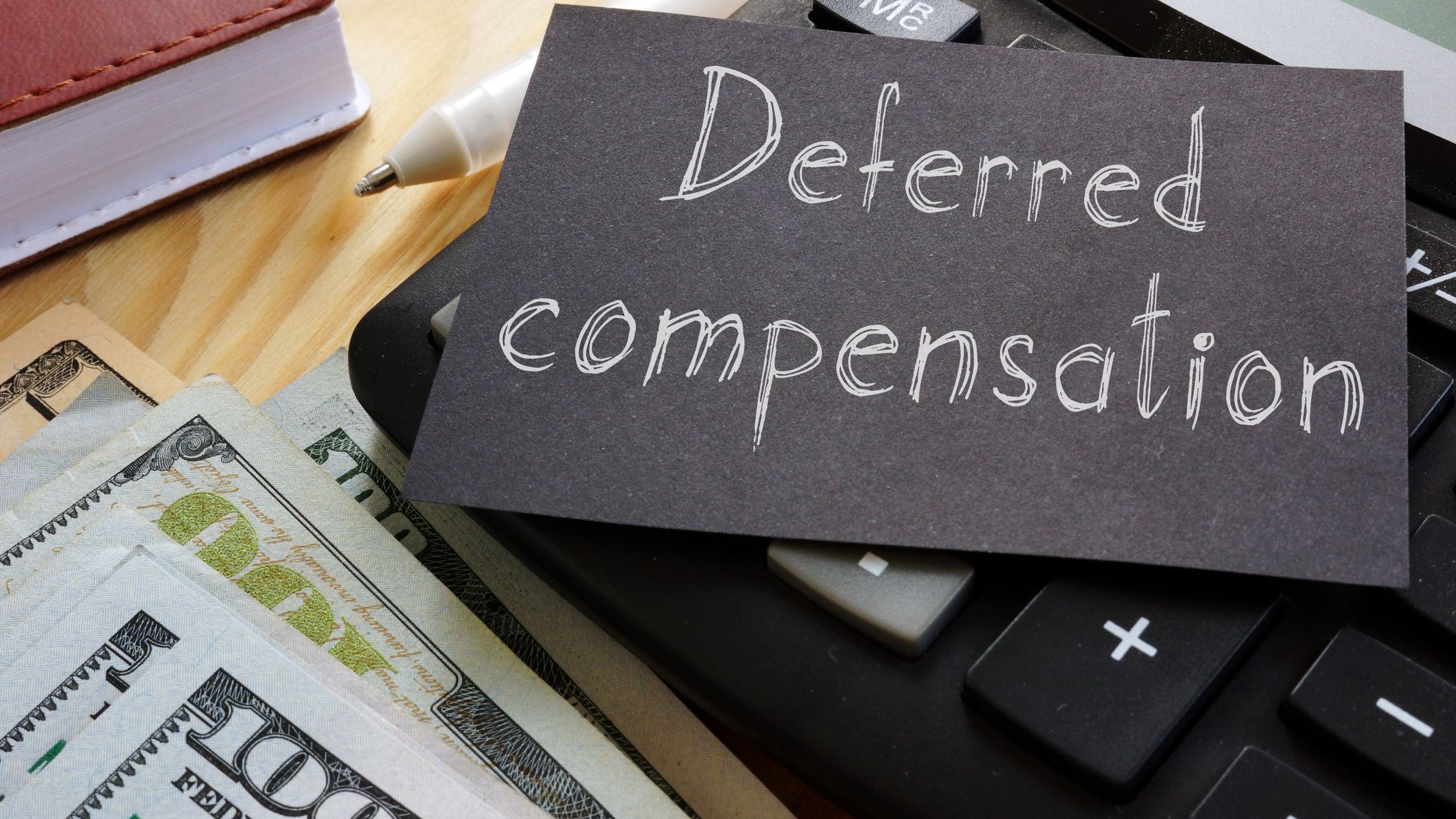 Deferred compensation is shown on a black piece of paper.