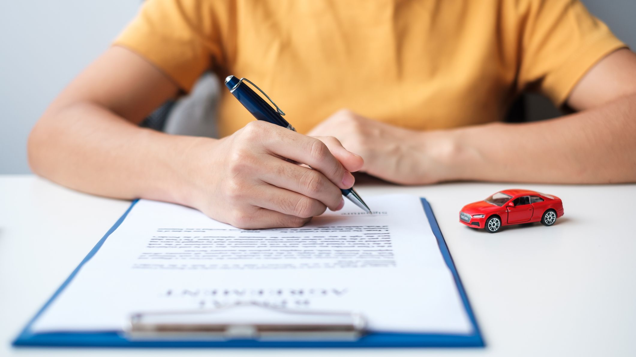 Woman hand signing contract document.