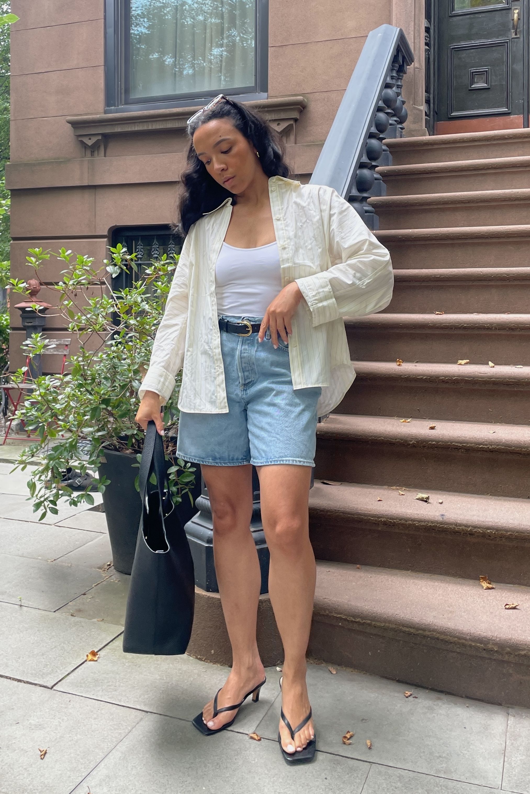 Lauren Tappan wearing a yellow button-down and denim bermuda shorts
