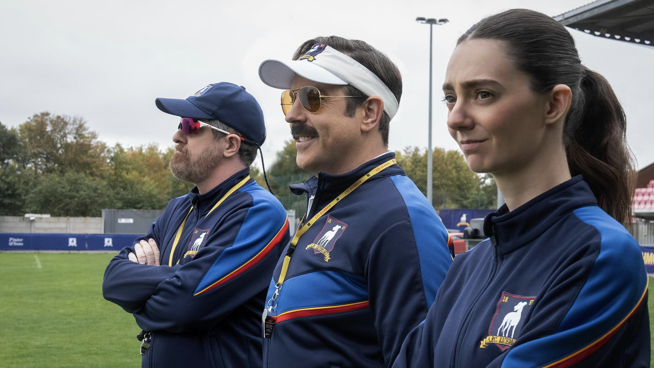 a production image from Ted Lasso showing the three coaches for the women's team