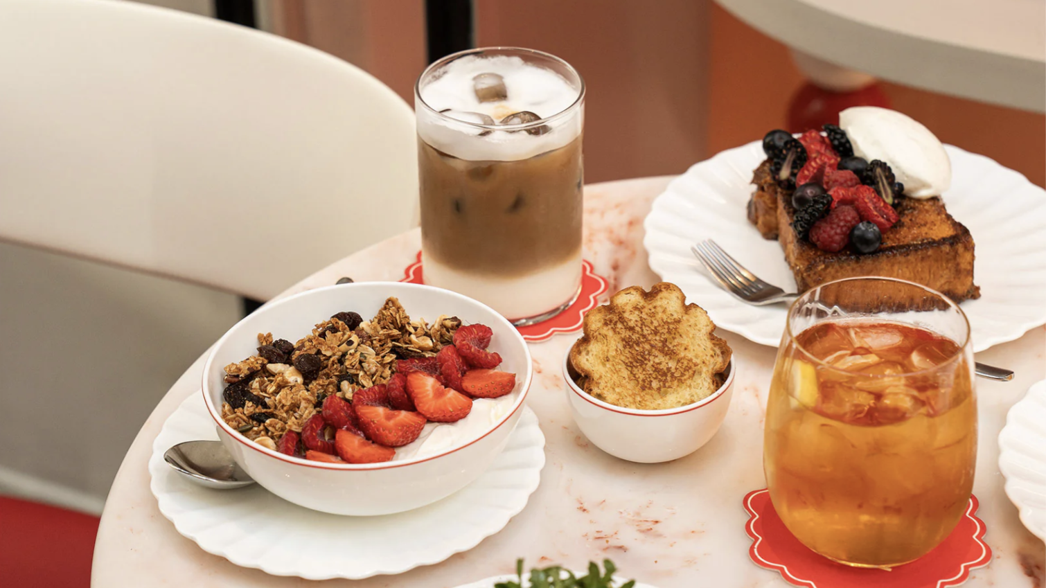 an image of some of the breakfast items on offer at Le Cafe, including avo toast, fruit granola, french toast and iced coffees and teas