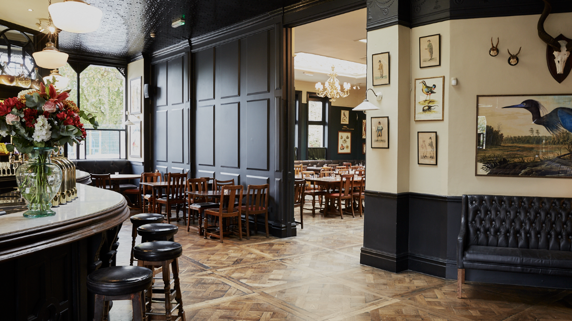 an image of the large horshoe bar inside the Princess Victoria pub in Shepherd's Bush in London