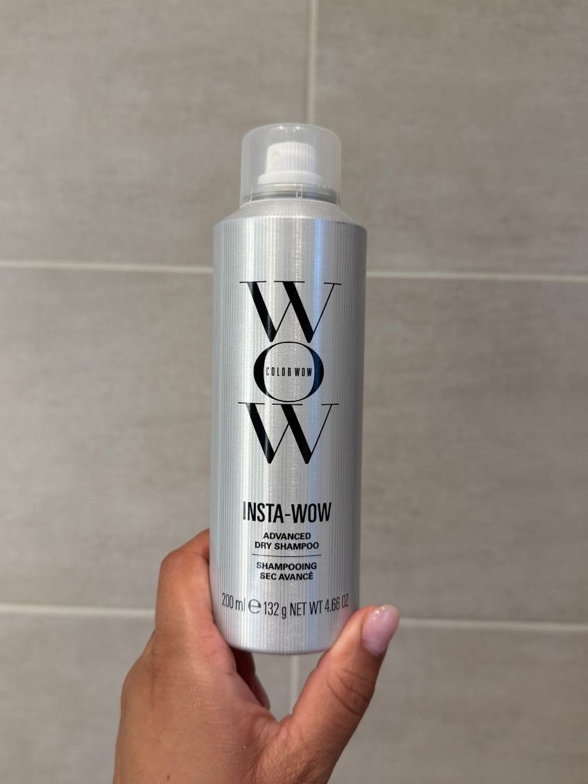 Aleesha holding empty Color wow Insta-Wow dry shampoo