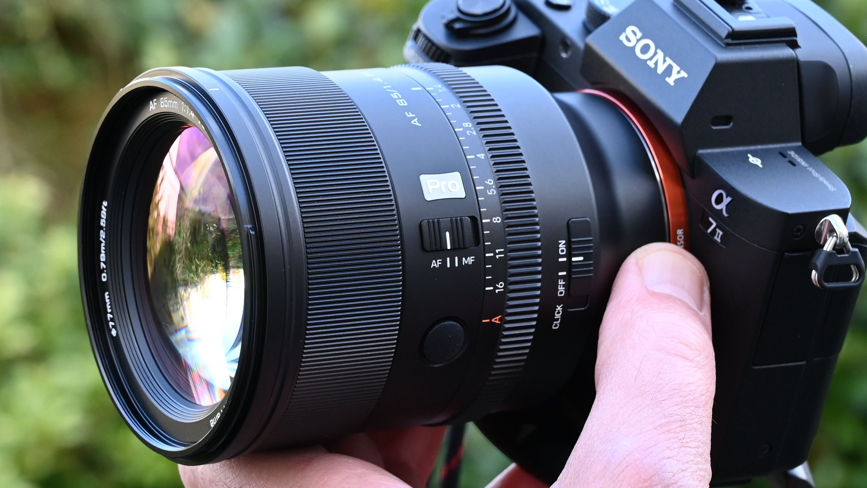 Viltrox AF 85mm f/1.4 Pro product shot, lens in hand