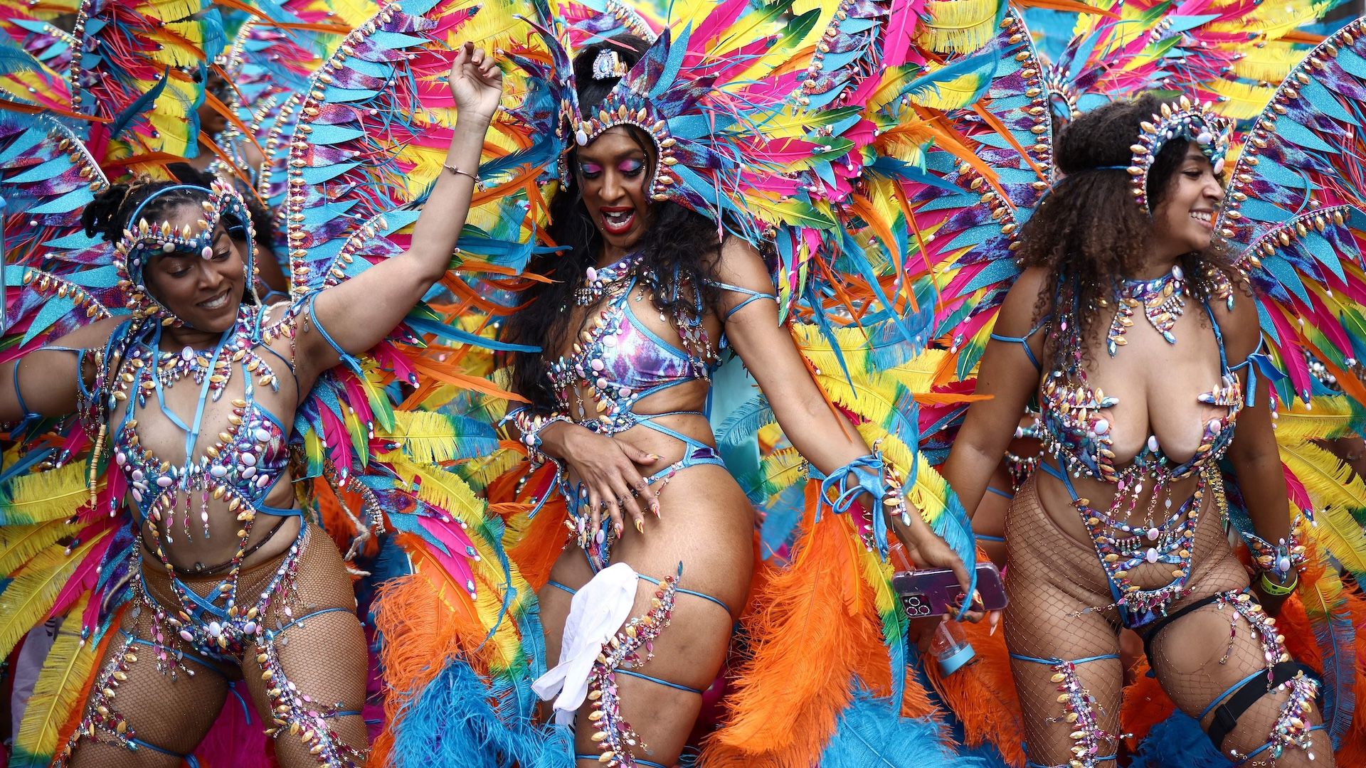 Performers in costume take part in the main parade of the Notting Hill Carnival in west London on August 27, 2023. (Photo by HENRY NICHOLLS / AFP) (Photo by HENRY NICHOLLS/AFP via Getty Images)