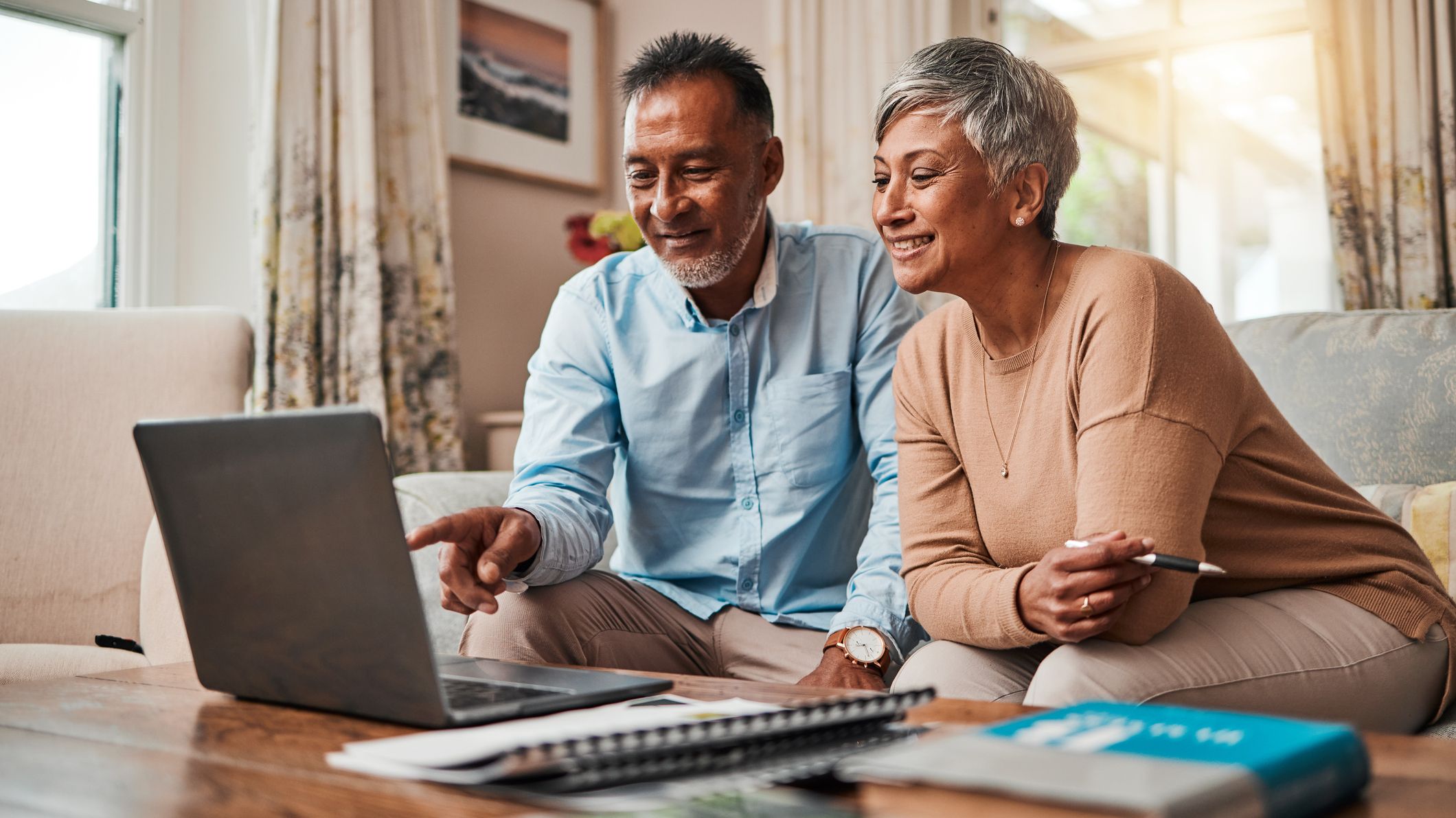 a picture of a couple looking on a computer for advice