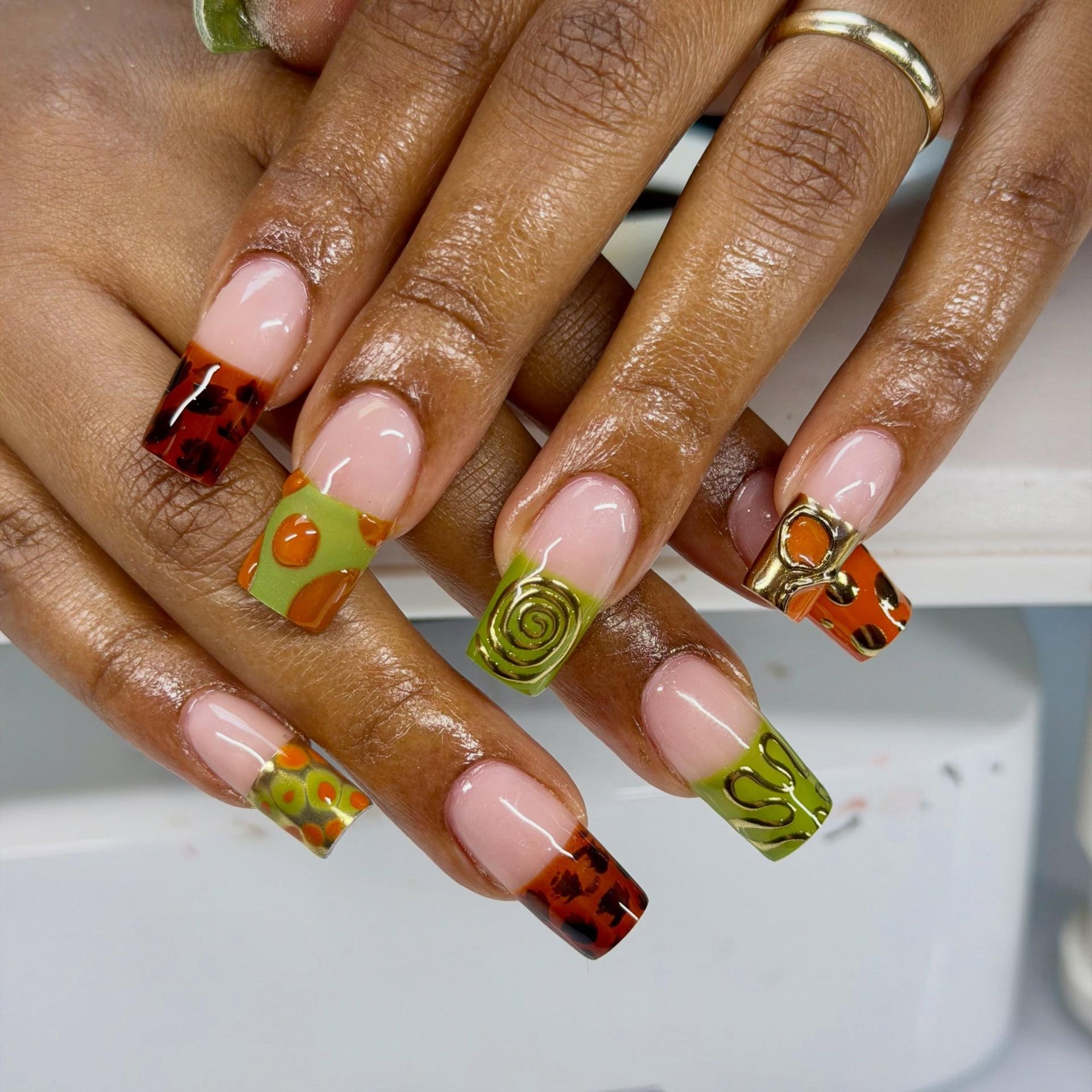 mixed nail design french manicure with green and orange patters