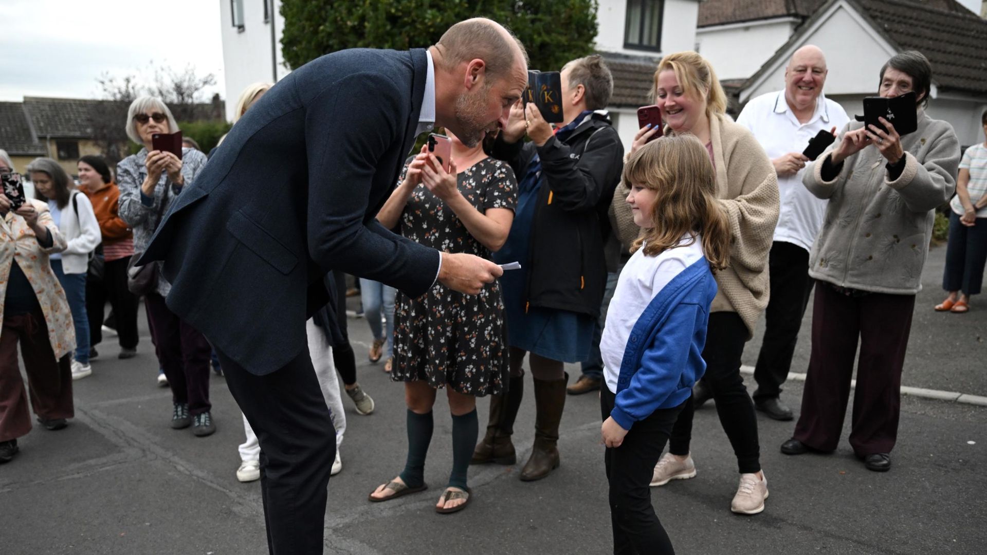 Prince William receives a card for Princess Charlotte from a young school girl during his visit to Ilminster Fire Station on October 06, 2026 in Ilminster, England.
