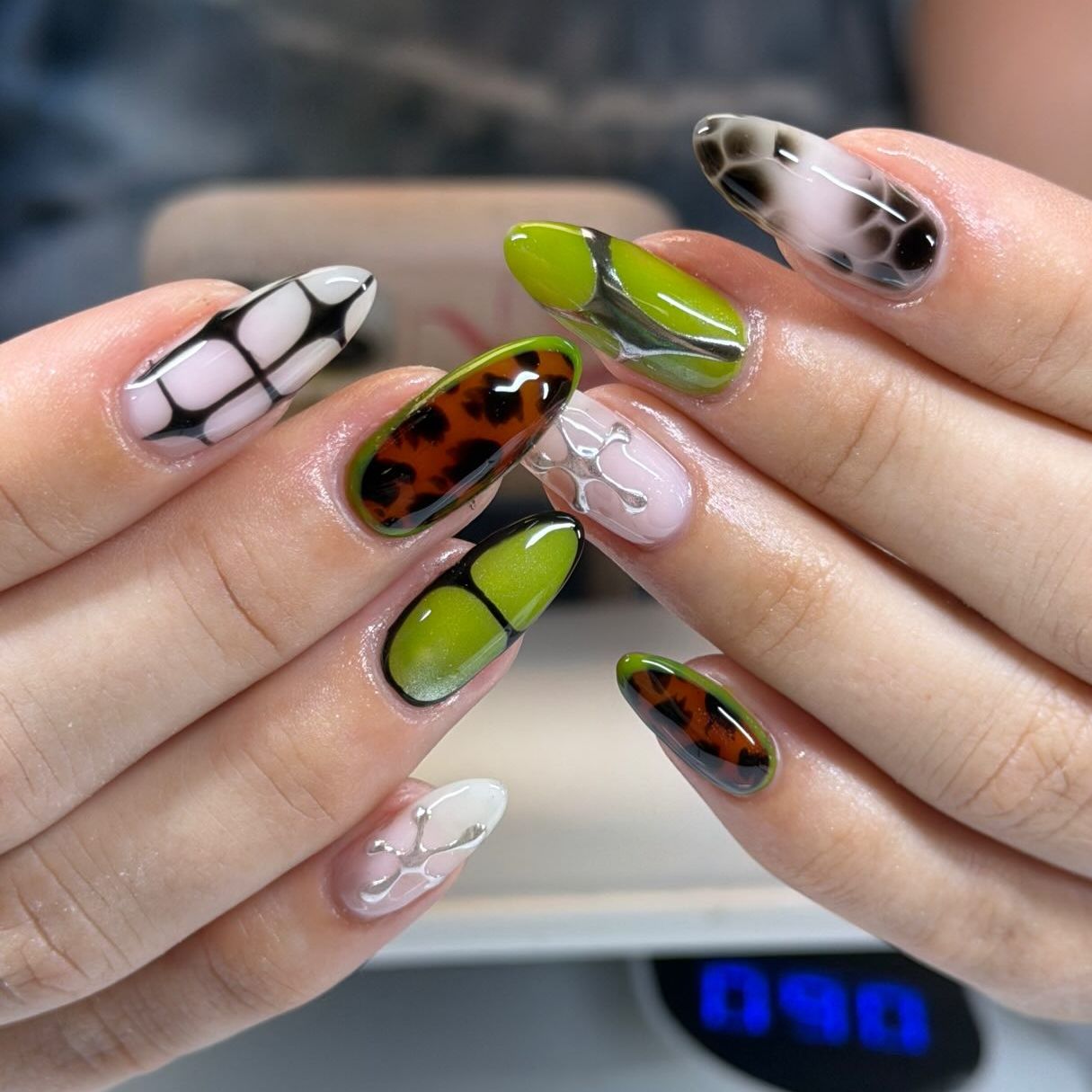 green nails that have cheetah print and snake decals