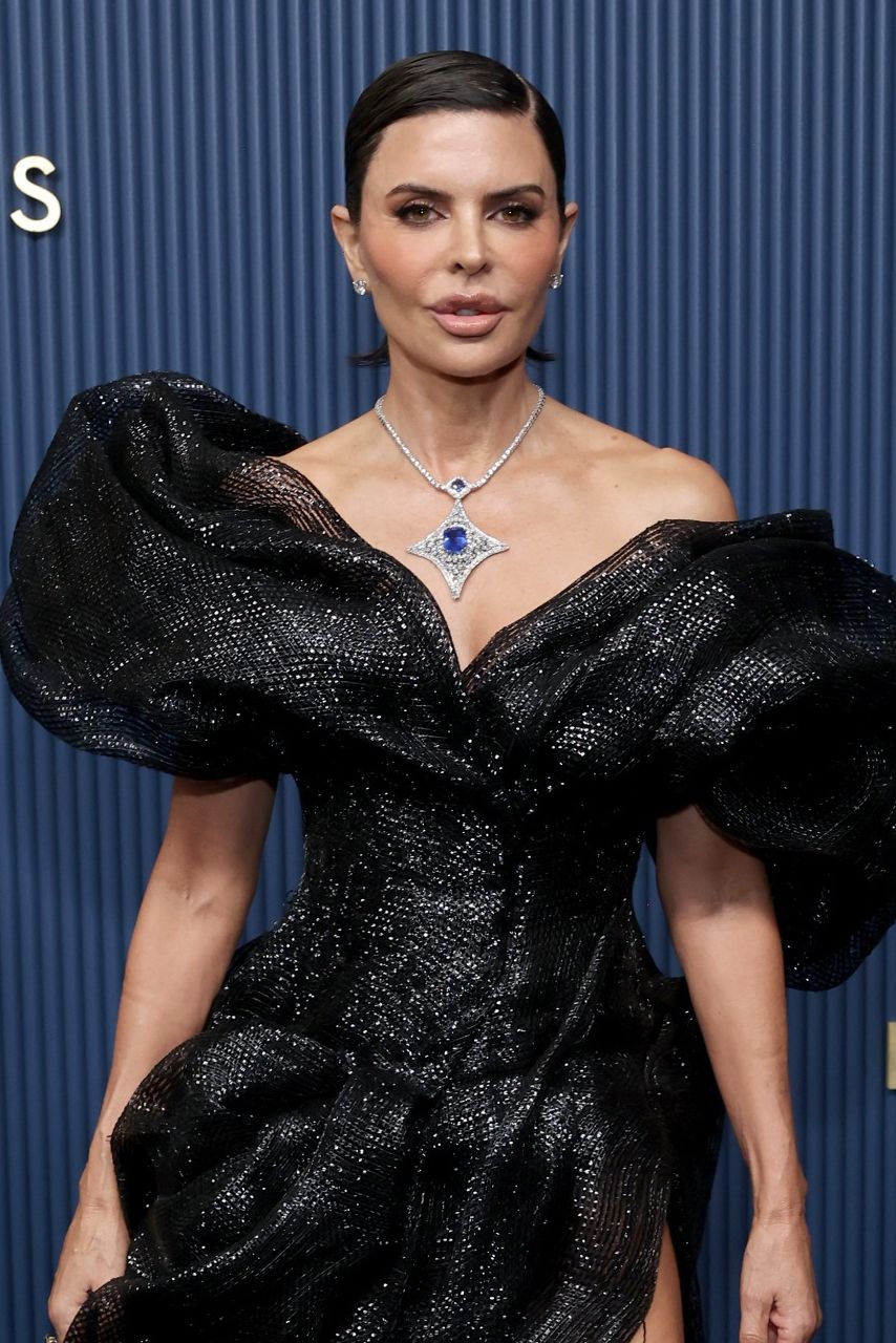 a white woman with a pixie cut in a black dress at the emmys