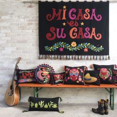 cushions with guitar and brick walls