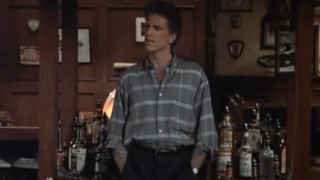 Ted Danson stands in an empty bar in Cheers.