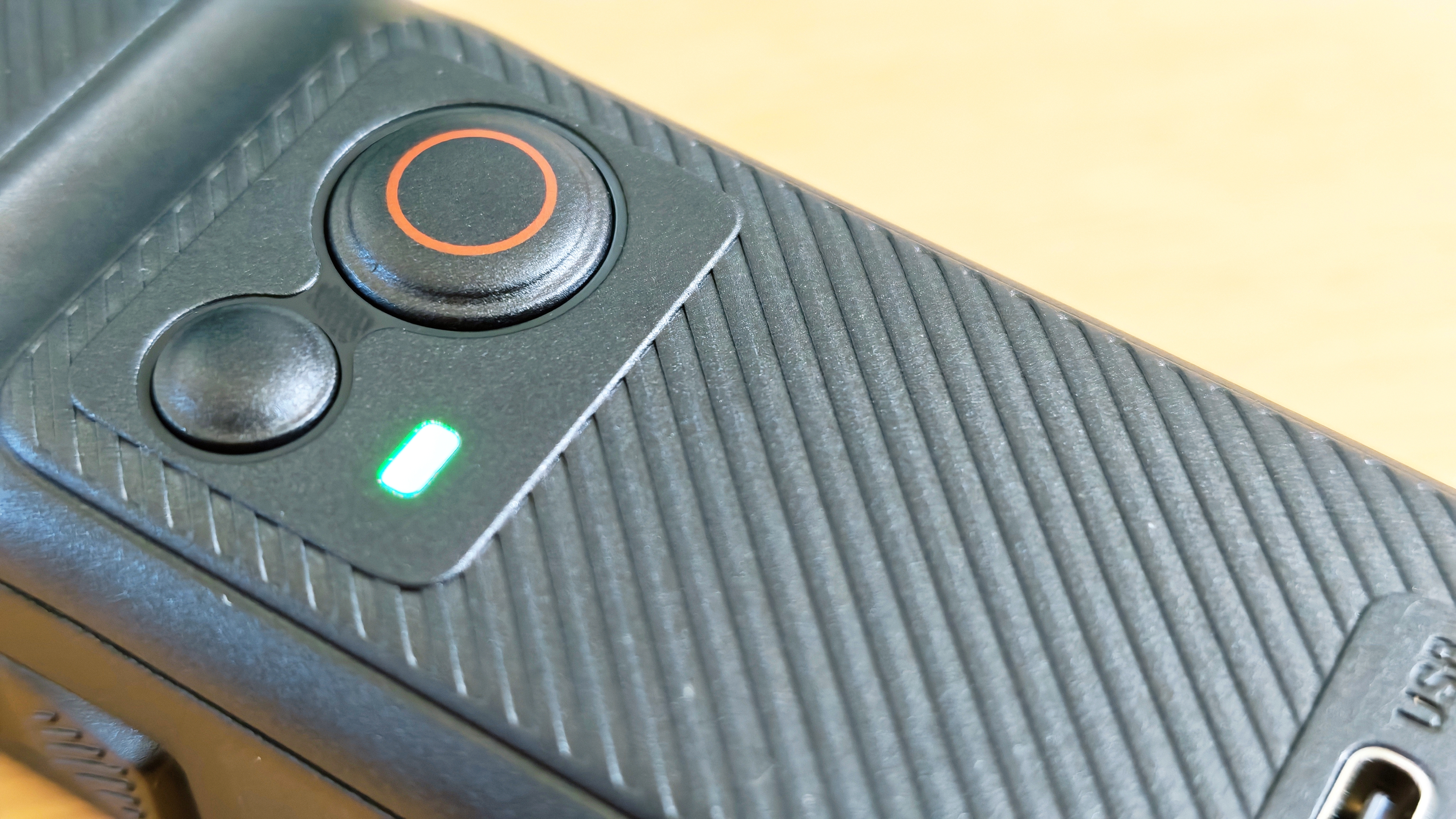 An SJCAM C400 on a wooden surface