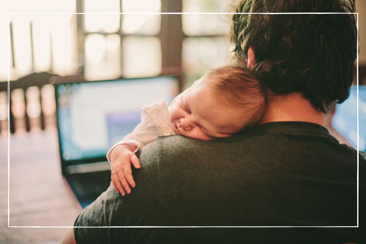 newborn baby asleep on father&#039;s shoulder