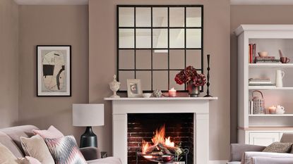 Mushroom living room with roaring fire and a window-style mirror above the fireplace