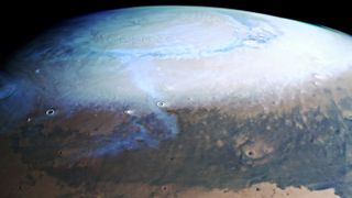 This view of the Red Planet, which is part of a larger image from the European Space Agency's Mars Express orbiter, shows bright clouds and over the planet's icy north pole contrasted against the dark and dusty plains further south. Mars Express captured this image using its High Resolution Stereo Camera.