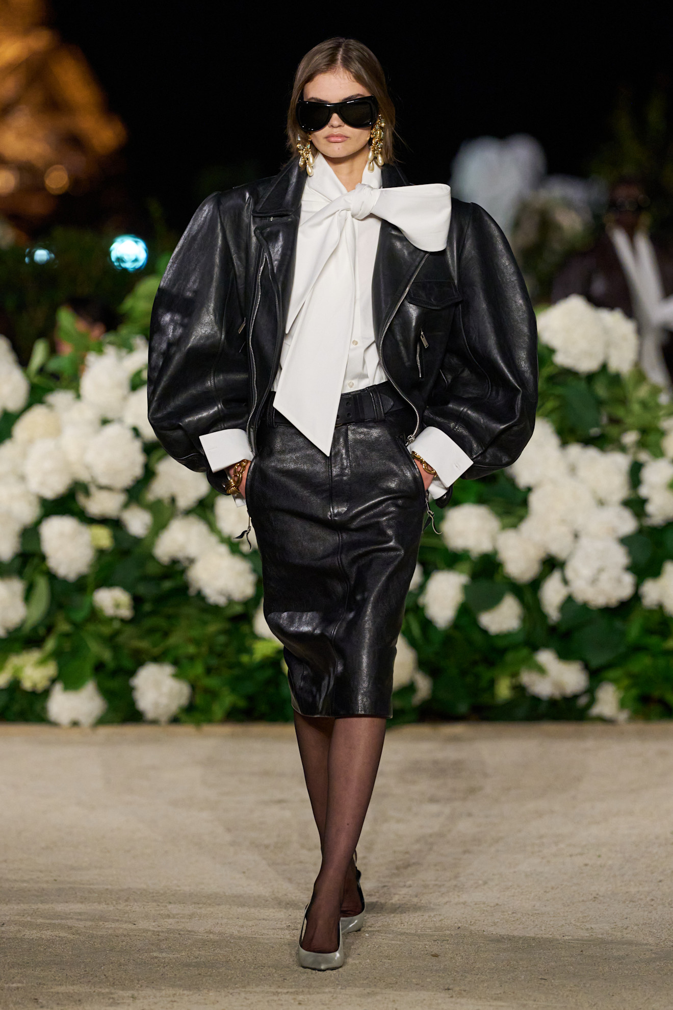 An image of a leather coat, one of the biggest spring coat trends for 2026, on the Saint Laurent spring/summer 2026 runway.