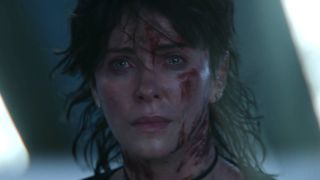 Charlie Theron bloody and crying after the final battle of The Old Guard 2