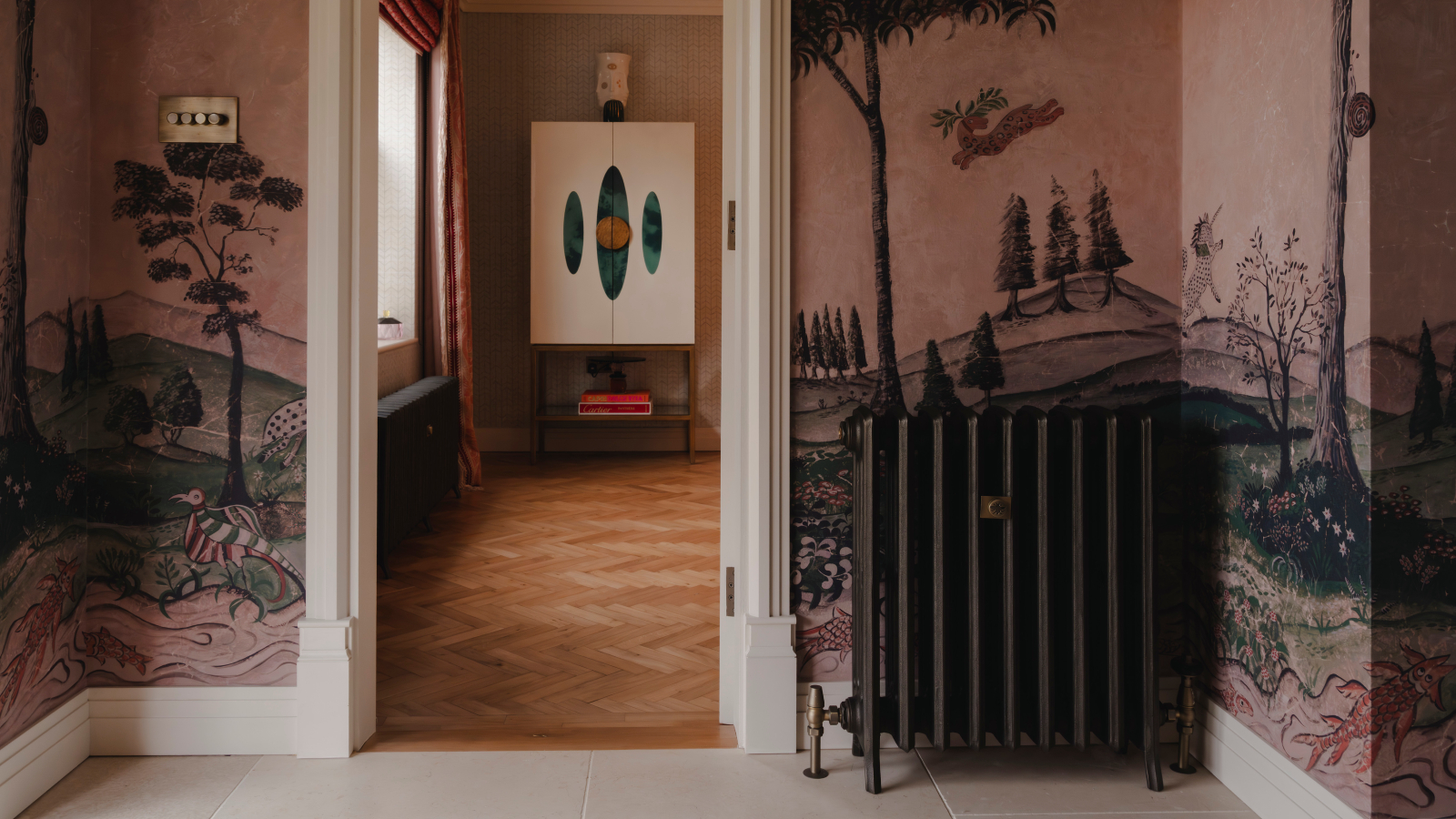 dark grey column radiator in hallway with wallpaper mural 