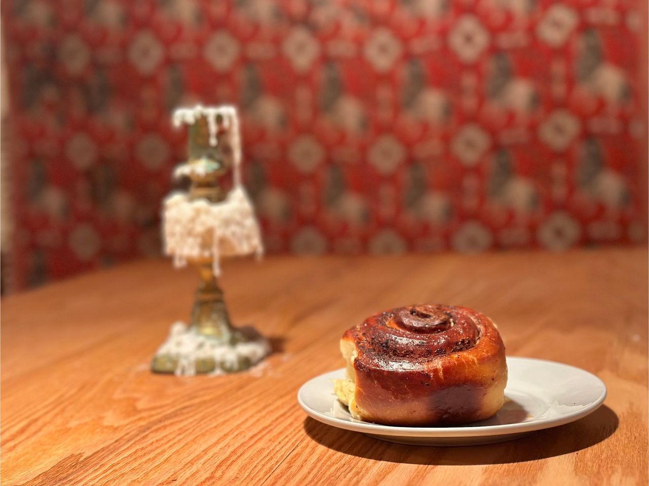 a cinnamon bun on a plate on a table