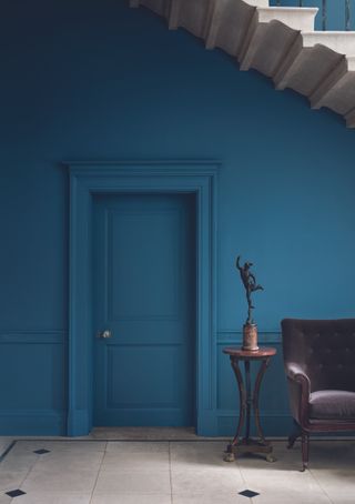 dark blue hallway with color drenching on doors and walls by Paint & Paper Library