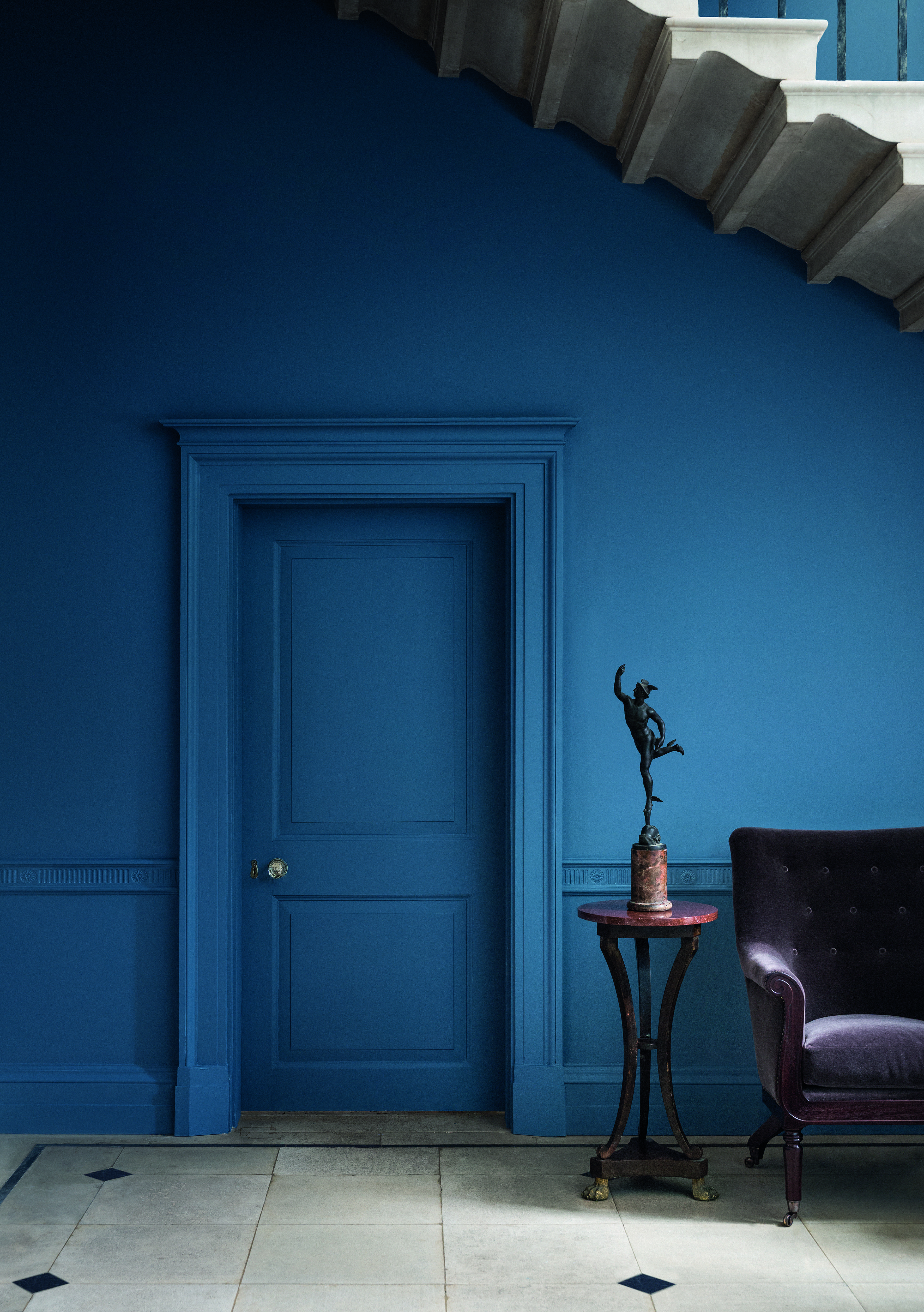 dark blue hallway with color drenching on doors and walls by Paint & Paper Library