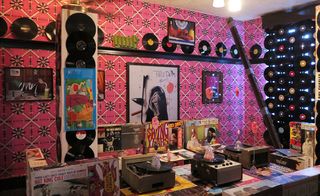 Installation view of a room decked out in LPs and found objects incorporated with Brinkmann’s sculpted ears