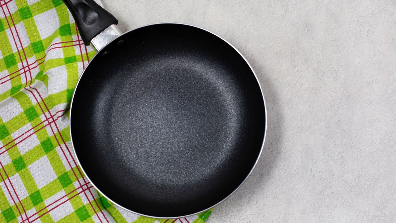 A black non-stick pan on a green cloth